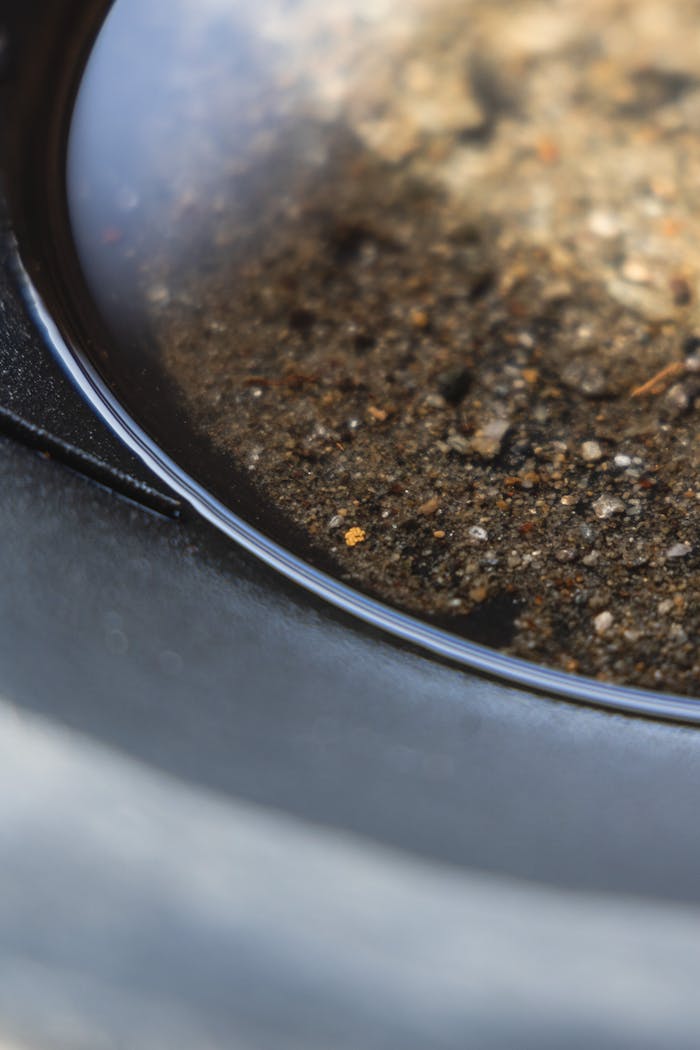 Detailed shot of gold panning with visible gravel and water reflecting light.
